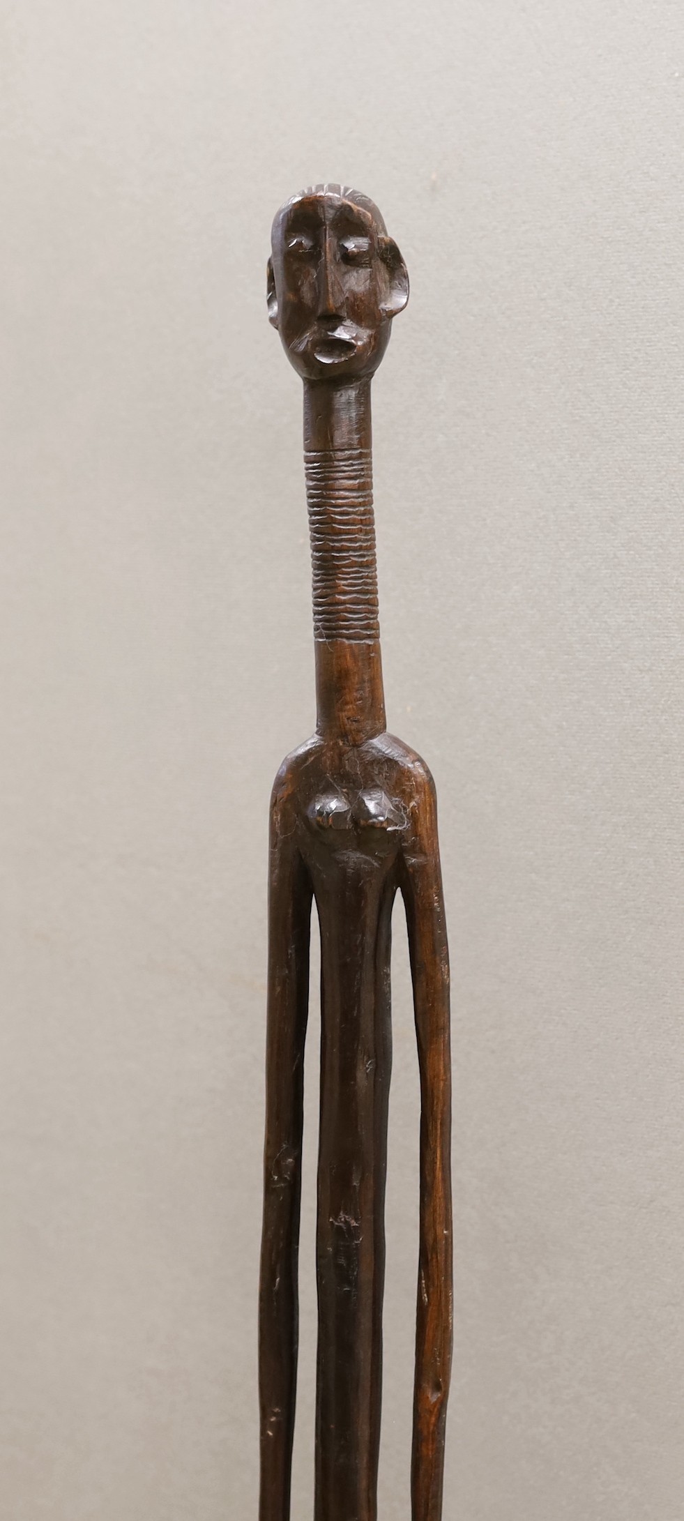 A West African tribal carved hardwood tall standing figure. 140cm high